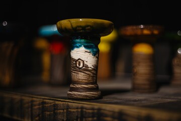 Closeup of a Kolos hookah bowl on a wooden table - obrazy, fototapety, plakaty