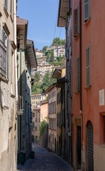 Fototapeta na wymiar Vertical shot of an alley between buildings on a sunny day in Borgo Canale, Bergamo, Italy