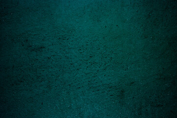 Teal colored abstract wall background with textures of different shades of teal
