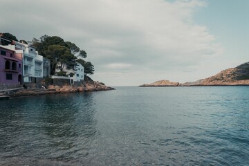 Group of similar houses near the stony beach on a clouded day