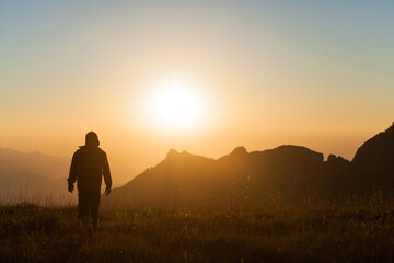 silhouette of a person in the mountains in sunset
