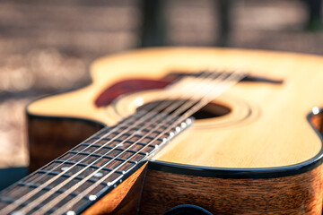 Fototapeta premium Close-up, classical acoustic guitar, soft focus in daylight.