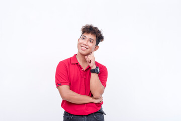 An optimistic young man thinking. Visualizing happiness. Thinking of a future career. Isolated on a white background.