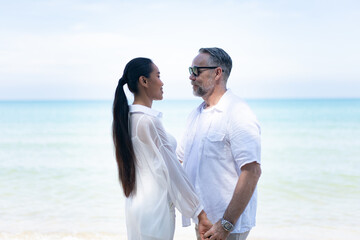 Romantic Couple Walking on the Beach. portrait of living young couple at the beach. Romantic marriage proposal at the seaside on the beach sea. Romantic marriage proposal on the beach.
