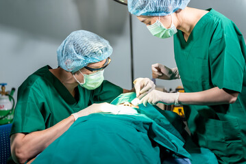 Asian medical team men and women working in the operating room, Doing nose surgery on a female...