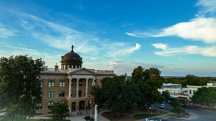 Architecture of Courthouse in Georgetown, Texas with street view, cars, trees and cloudy sky
