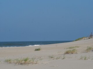 Beautiful sandy beach at Juist island in Germany with the North Sea and a in the background