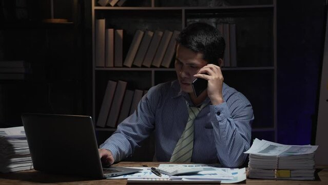 Businessman hard working with desktop computer to late night at office. Business people work overtime. Concept of salary man.