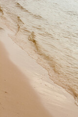 Sea wave on the sand in the fall
