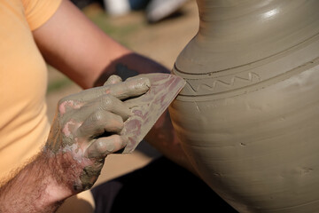 Potter Decorating The Clay Pot