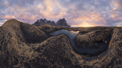 Mountain range against cloudy sky during sunset