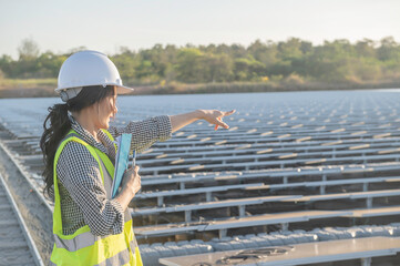 Asian engineer working at Floating solar farm,Renewable energy,Technician and investor solar panels checking the panels at solar energy installation