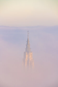 Amazing cloudy sunset sky with sharp peaks of cathedrals