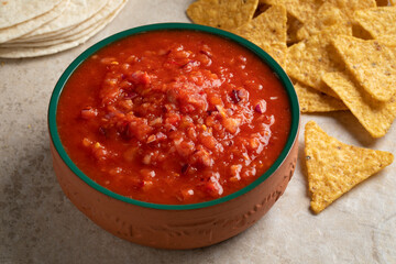 Mexican bowl with fresh made salsa close up with tortillas and chips for a snack or meal
