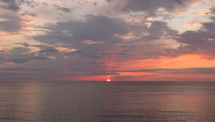 Calm sea with sunset sky with cloud.