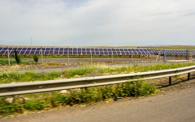 Solar power plant in a farmland captured by a highway in Turkey