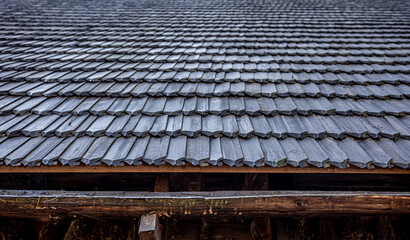Close-up, the roof of a house made of wooden tiles.