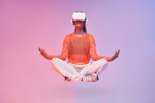Female meditating in virtual reality