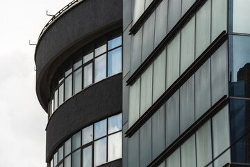 Front wall of a business building full of reflective windows. Corporate structure with many windows