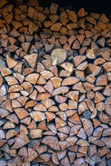 Wall of stacked wooden logs as background.