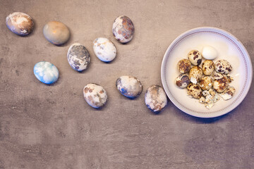 eggs on concrete. Happy Easter card: marble stone effect painted. top view, quail eggs flat lay