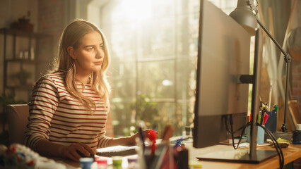Smiling Female Teen Working on her Personal Computer. Sitting Behind the Desk in Loft Sunny Room....