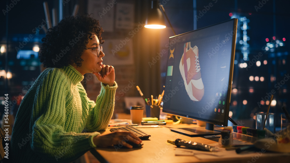 Aufkleber black female art director reviewing 3d model of shoe, working on powerful desktop computer at home. 