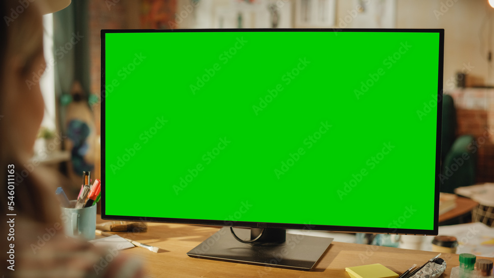 Poster over the shoulder shot of professional freelancer working on personal computer with green screen moc