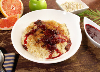 Porridge in a white Bowl; Oatmeal with Berries and Cinnamon