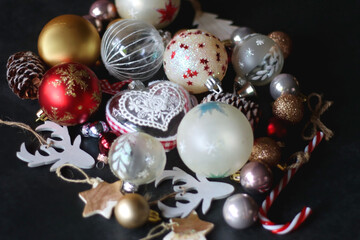 Various colorful Christmas ornaments on dark background. Selective focus.