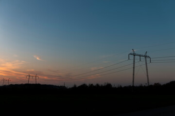 Fototapeta na wymiar High voltage power lines at sunset.In future - scarcity of electricity. Due to high prices desperate people have no money to pay for electricity