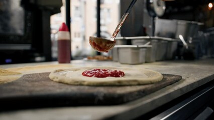 Professional chef makes traditional margarita pizza add tomato paste, cheese on pizza