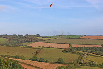Paraglider above fields of Devon at Beesands