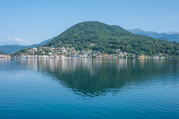 Fototapeta na wymiar landscape of the Lake Lugano with Ponte Tresa reflecting on the water