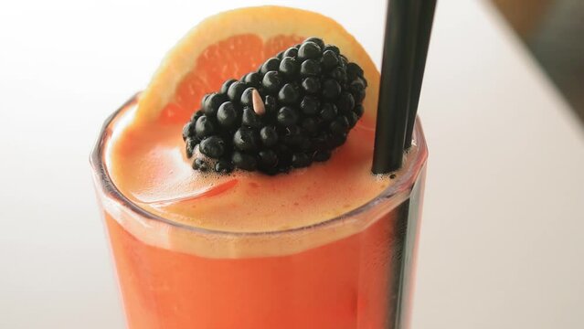 Delicious refreshing alchocolic cocktail Tequila Sunrise served in a summer brach bar