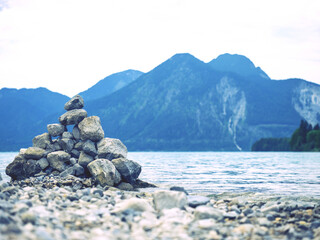 Stones pebbles stacked in a Zen pyramid on Walchensee coast.