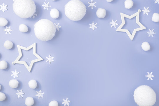 Christmas composition. White balls, snowflakes, gifts and Christmas trees on a purple pastel background