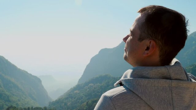Cinematic beautiful shot of young travelling man, breathe fresh air