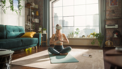 Young Fit Female Wearing Virtual Reality Headset, Practising Meditation in Modern Futuristic Way in...