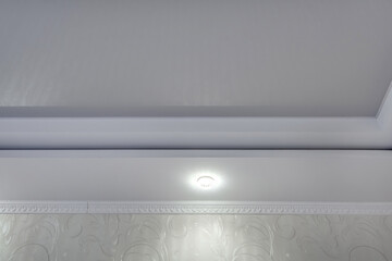 Detail of corner ceiling with intricate crown molding. Suspended ceiling and drywall construction...