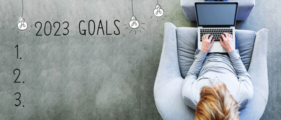 2023 goals with man using a laptop in a modern gray chair