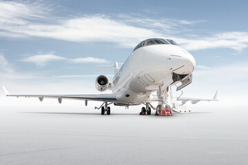 Modern white private jet with an opened gangway door isolated on bright background with sky