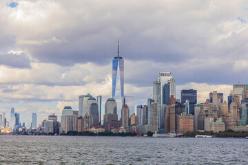 Beautiful panoramic view of skyscrapers of Manhattan from Hudson River under blue sky with white clouds. New York, USA.