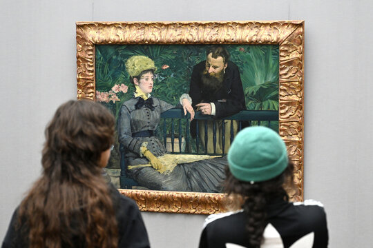 Berlin, Germany - November 03, 2022: Visitors observing "In the Conservatory", 1879 oil painting by Edouard Manet in the Alte Nationalgalerie in Berlin.