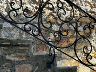 Ancient staircase with stone steps and wrought railing. 