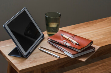 Accessories for education, work - notebooks, tablets, stationery on a wooden table