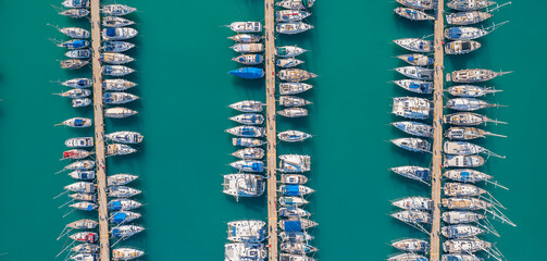 Concept banner travel cruise. White Yacht and boats parking in mediterranean sea pier, Aerial top view