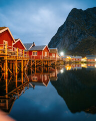 Fototapeta premium Reine at night, Lofoten, Norway. Traditional Norwegian fisherman with cabins. Photographed at dawn in autumn or winter.