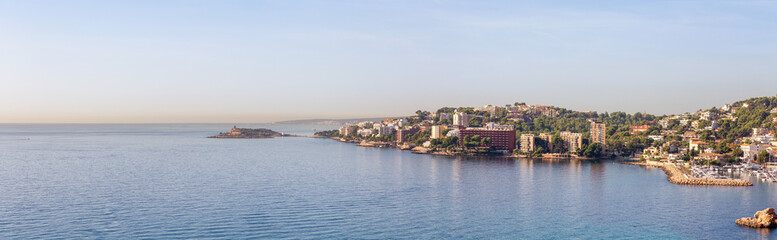 Fototapeta na wymiar Rocky Shores, Colorful Blue Sea Water and Residential Homes on Mediterranean Coast. Palma, Balearic Islands, Spain. Aerial Panorama