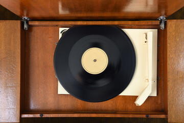 Vintage record player spinning vinyl in a cozy living room